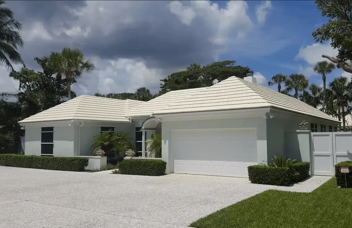 Freshly repainted white home exterior with palm trees